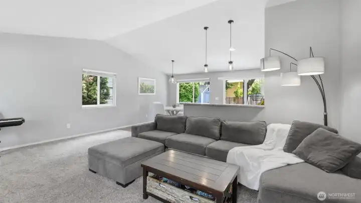 Vaulted ceilings greet you upon entry, creating an open and inviting main living area filled with natural light.