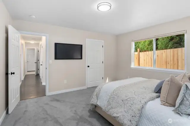 NEW plush carpet! The PRIMARY BEDROOM is private retreat with an en-suite bathroom and generous walk-in closet!