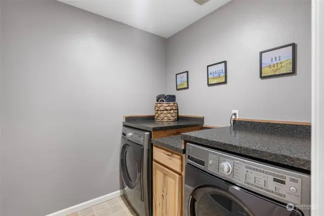 Large laundry room with custom built cabinets and folding counter tops.