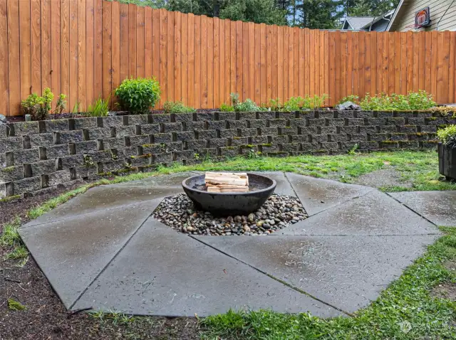 Custom cement pad encasing the outdoor firepit.