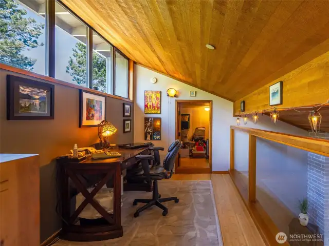 The cozy, functional loft adds space and character to this condo. Note the 10' x 10' bonus storage room in the background!  Great place to store your seasonal belongings.