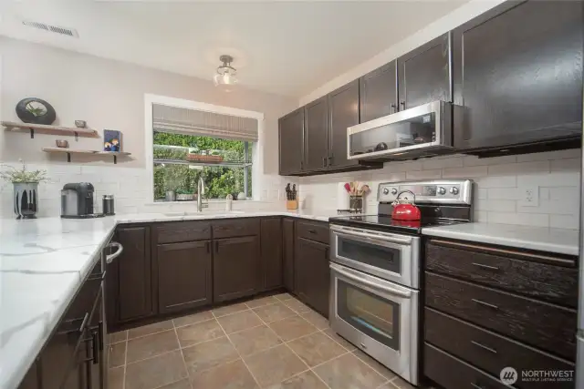 Beautiful gourmet kitchen, updated appliances, quartz counters and eating space.