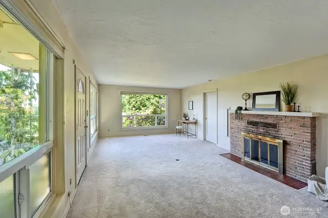 Front living room with wood burning fireplace.