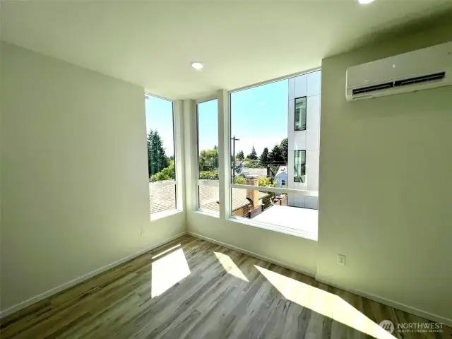 Living room corner windows facing south and west for maximum light exposure!