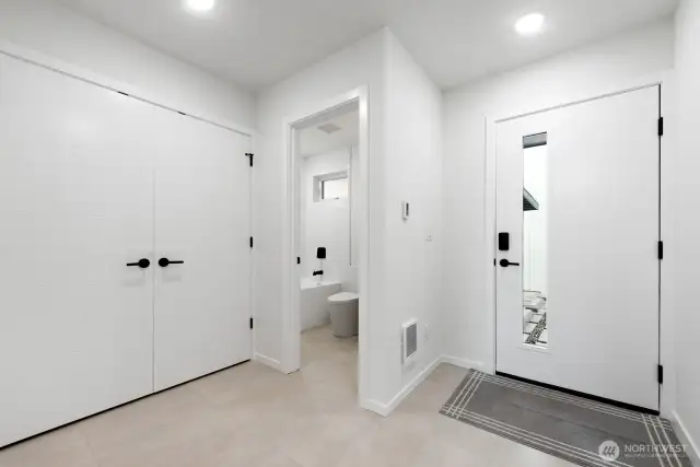 Another view of the entry and full bath. Model home, colors and finishes may vary.