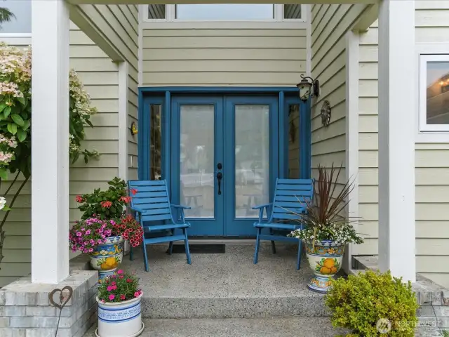 Covered front doorway entry with glass doors await your entry.
