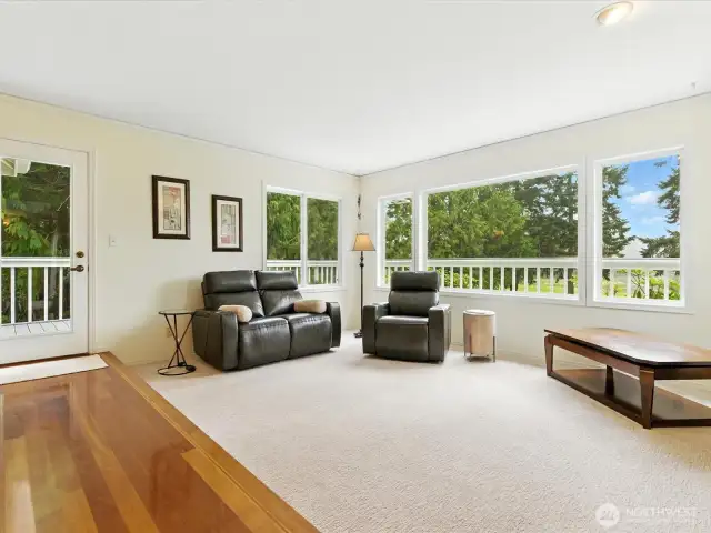 2nd photo of living room adjacent to kitchen. Access door to deck.