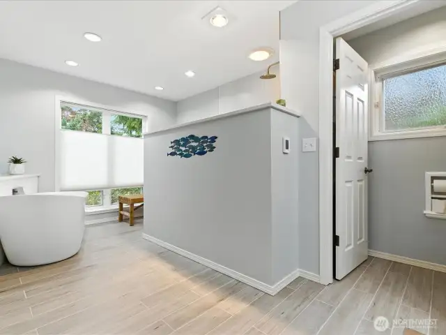 Entering this updated preimary pathroom, notice heated flooring, large bathing tub and updated walkin shower, stunning!
