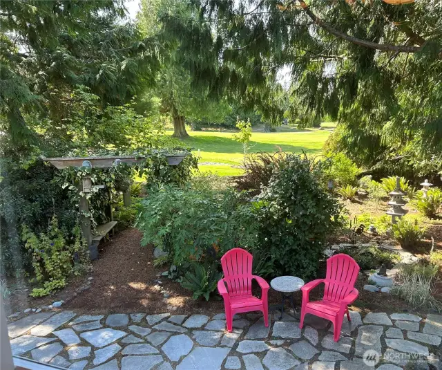 Always something blooming around this gorgeous home. Quiet and alluring spot to relax in a very private area of the backyard.