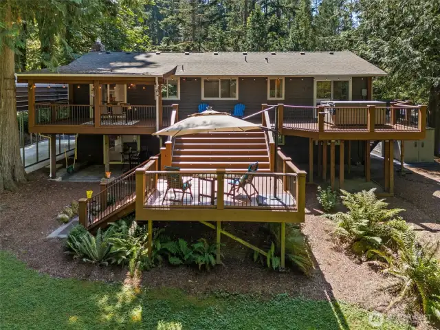 Two level deck in the back of the home takes advantage of the natural privacy of the property. There is even a small patio off the lower level huge family room that stays dry year round, and little kids swing is waiting for that next small person to use!