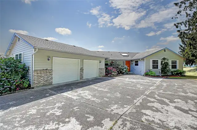 Large, paved driveway that takes you to main entrance and three car garage!