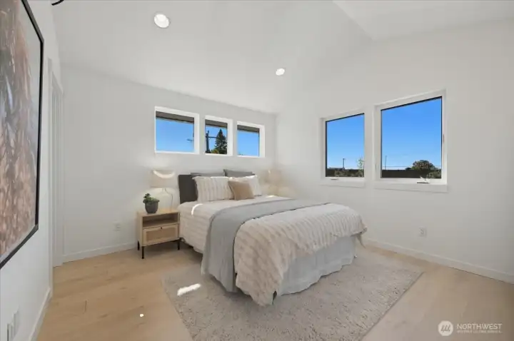 Primary Suite with hardwoods and vaulted ceilings