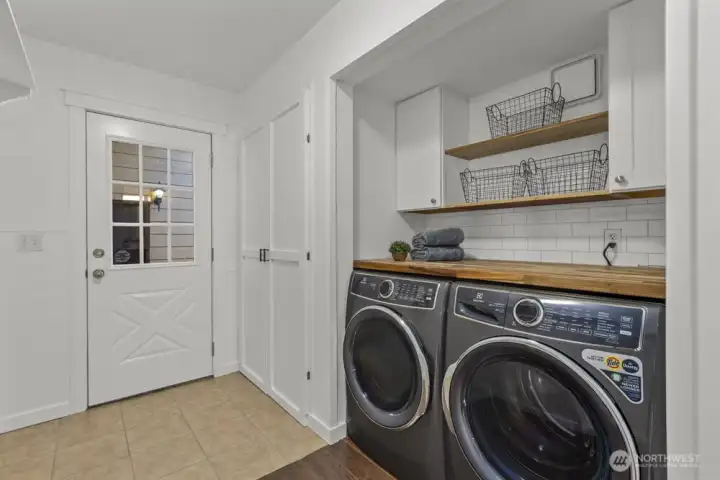 Step through the door to a covered patio that connects seamlessly to the huge detached shop.