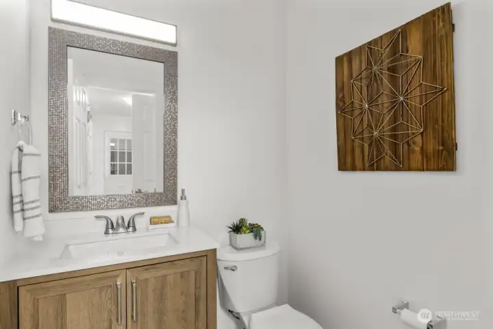 Just off the laundry room, you’ll find a convenient powder bath for guests.