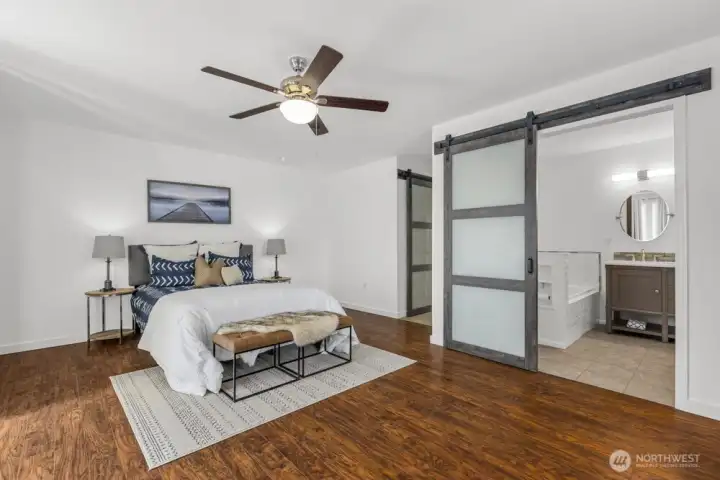 The main-floor primary, quietly tucked away, offers a private and peaceful retreat.