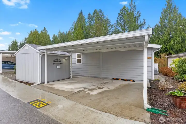 Large covered carport with storage shed