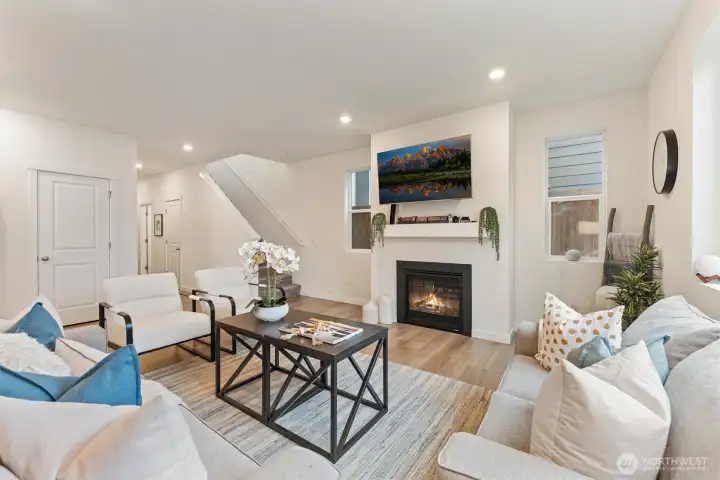 Cozy living room anchored by a gas fireplace, creating a warm and inviting gathering space.