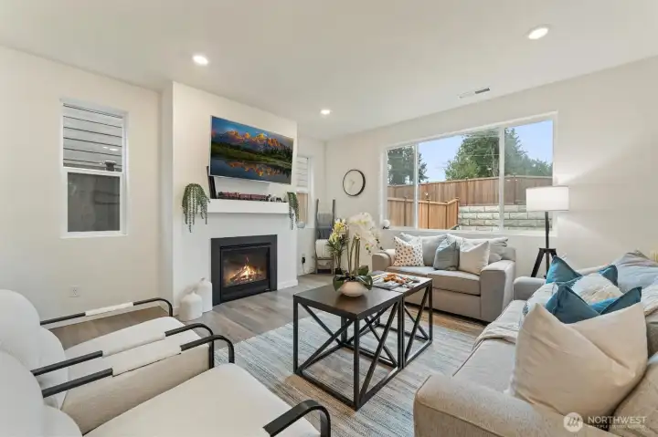 Another view of the living room highlighting the open layout and backyard sightlines.