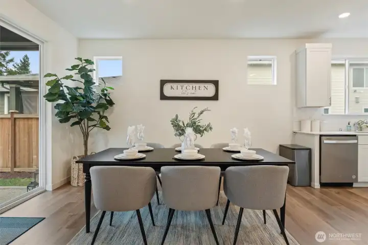 Casual dining space with sliding glass door leading to the covered patio and fenced backyard.