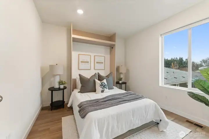 Secondary bedroom with natural light and flexible layout for guests or home office use.