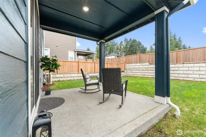 Covered backyard patio offering year-round outdoor living and entertaining space.