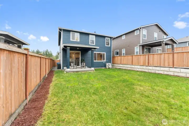 Fully fenced backyard with level lawn—perfect for play, pets, or gardening.