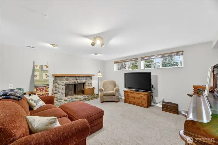 FAMILY ROOM  Wood burning fireplace with locally sourced Cedar River rock with wood mantle. Exterior brick repointed 2021