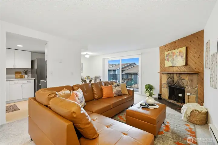 Cozy living room centered around a charming wood-burning fireplace, perfect for relaxing evenings.