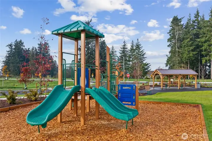 Tot lot with play structure and 3 slides.
