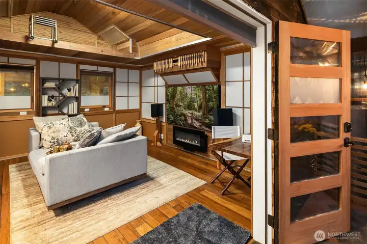 Inspired by a Japanese style, the owner's son transformed this into a bunkhouse.  It does have running water (gray water), a small refrigerator, closet, an electric fireplace heating and is a fun place to escape.