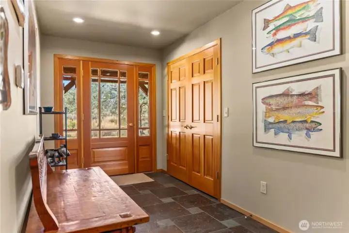 Entryway with large closet, slate flooring and a welcoming warmth.