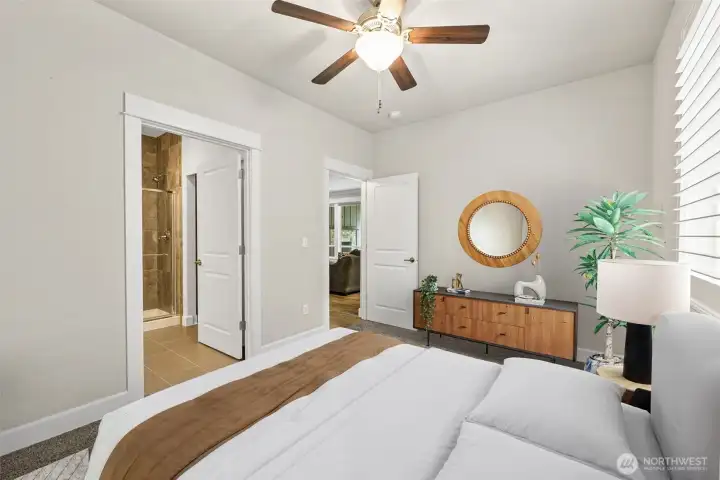 Second primary suite on the main level w/attached 3/4 bath, offers great guest space, multi-generational or rental options. Photo is virtually staged.