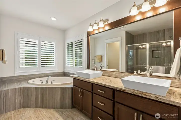 5 pc primary bathroom w/granite counters and tile surround in tub and shower.