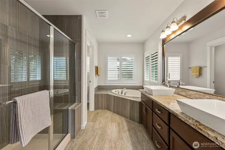 5 pc primary bathroom w/granite counters and tile surround in tub and shower.