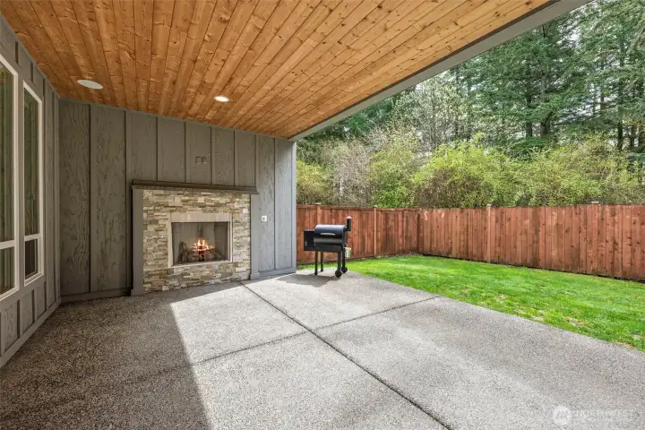 Covered patio w/gas fireplace, tv hookup, speaker system, tongue & groove ceiling and lighting, enclosed on 3 sides.
