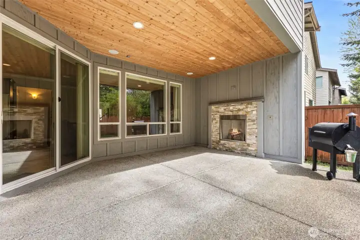 Covered patio w/gas fireplace, tv hookup, speaker system, tongue & groove ceiling and lighting, enclosed on 3 sides.