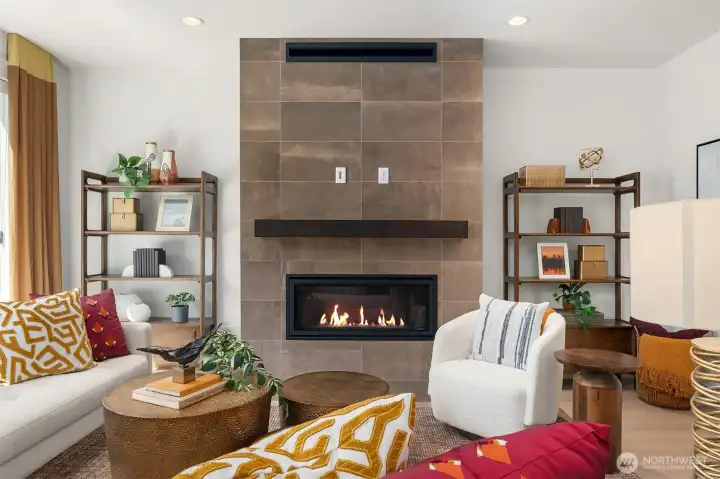 Gas fireplace with tile extending to the ceiling and beautiful wood mantel