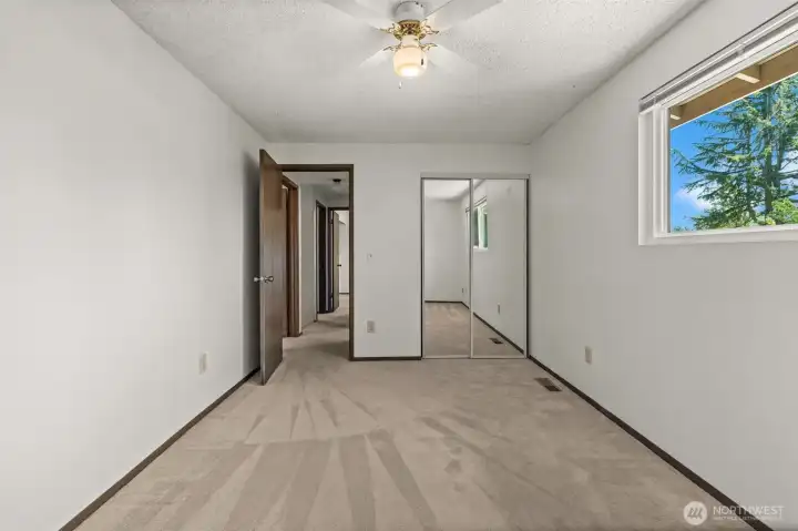Bedroom #2 - Mirrored closet and leafy view.