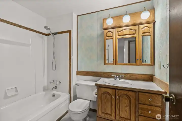 Full bath with a tub/shower combo.