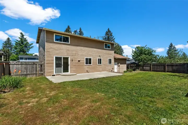 Out back: big patio and plenty of grass.