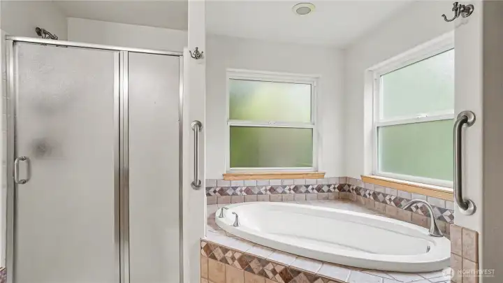 En-suite boasts five-piece bath with soaking tub.