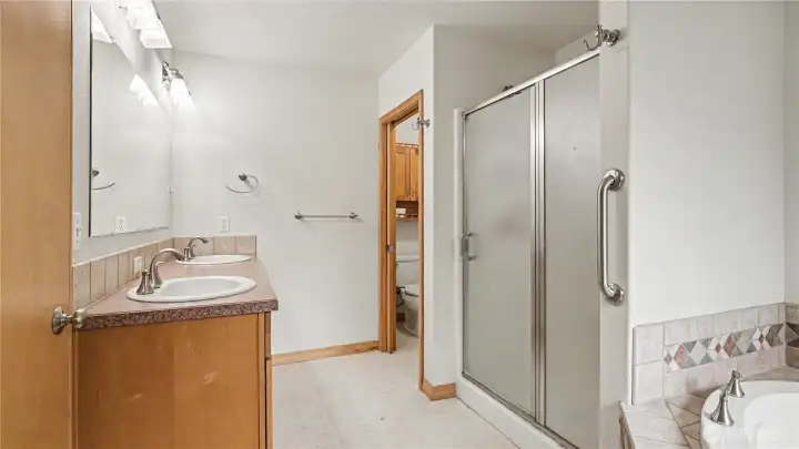Well-designed bathroom offering dual sinks and a separate water closet for added privacy.