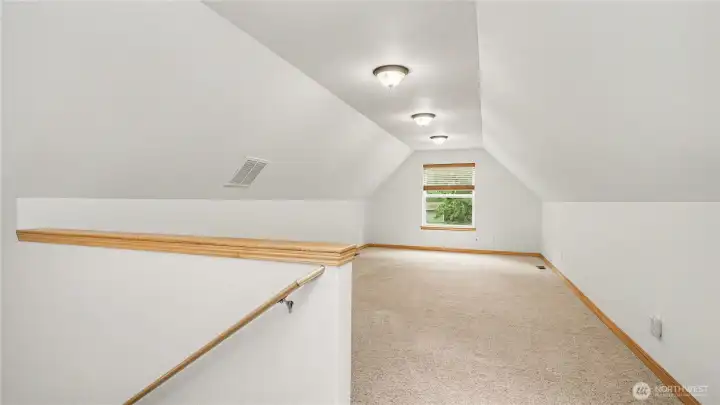 Large upstairs bonus room ready for a media room, play space, or secondary living area.
