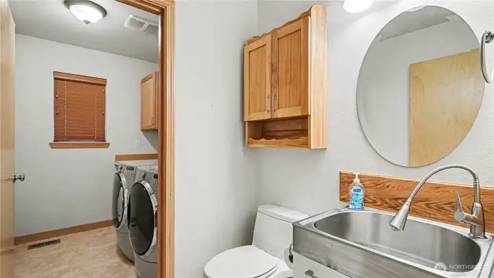 Main floor half bathroom connected to the laundry room.