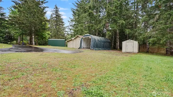 Additional highlights include plentiful storage, an additional covered parking space that could fit a small RV or boat and outdoor sheds, including one with power ready for hobbies, projects, or workshop use.