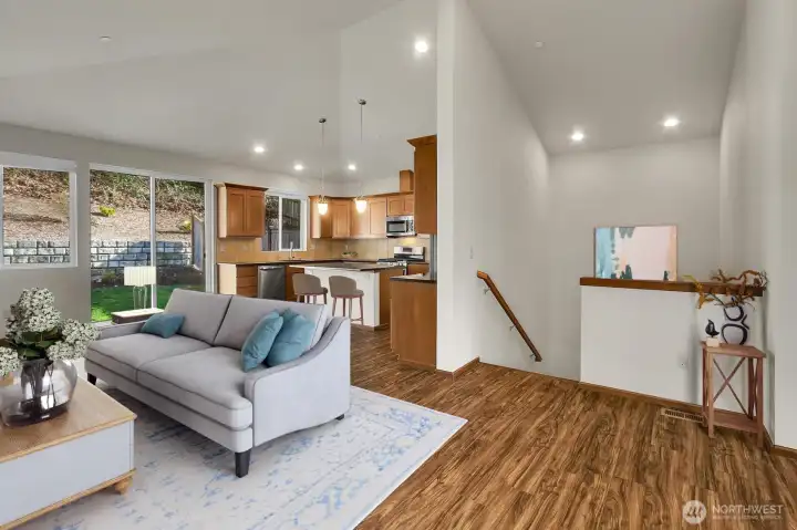 The open floor plan with vaulted ceilings creates a spacious atmosphere in the main living area on the upper level. Virtually staged. The open floor plan with vaulted ceilings creates a spacious atmosphere in the main living area on the upper level. Virtually staged.
