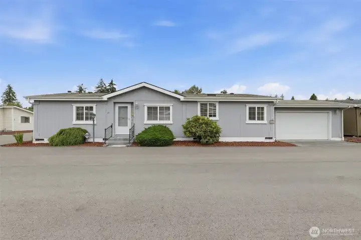 Street view of this well cared for home. Three steps up to the formal entry. Attached 2 car garage with storage space and access door into the untility room into the home.