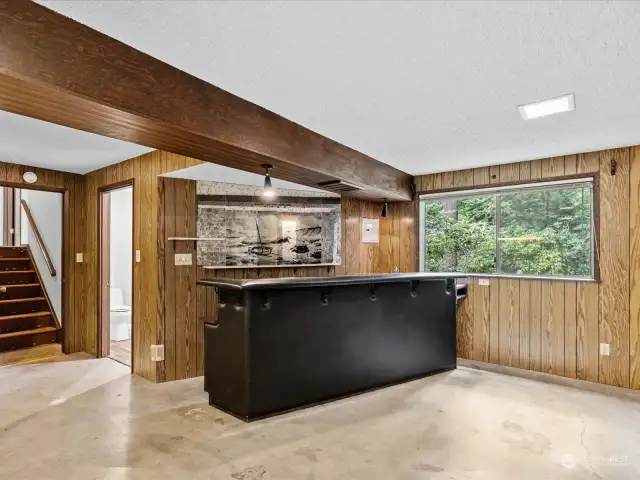 Basement bar area with stairs that lead to main level