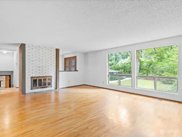 Living room off entry has wood burning fireplace