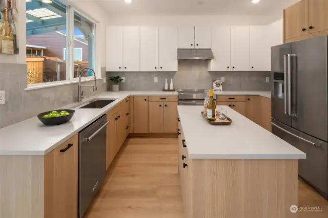 Brand new kitchen with Belmont cabinets, quartz, full-height tile backsplash and KitchenAid appliances